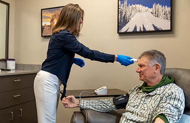 Nurse taking a patient's temperature