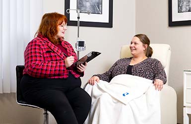 Nurse tending to an infusion patient